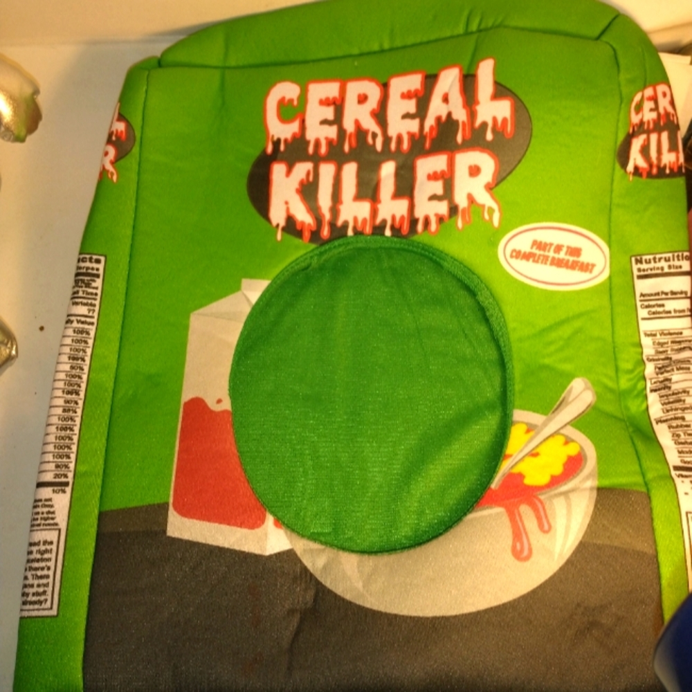 Padded foam cereal box goes over head face in opening.